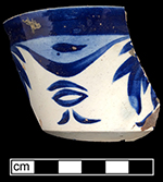 Pearlware painted underglaze London shape cup with leafy swag motif. Above left is photograph of interior of cup. Saucer had impressed mark “H” from undetermined maker. 3.75” cup rim diameter 2.25” cup height; 5.5” saucer rim diameter; There were three matching cups and one matching saucer in the privy assemblage.